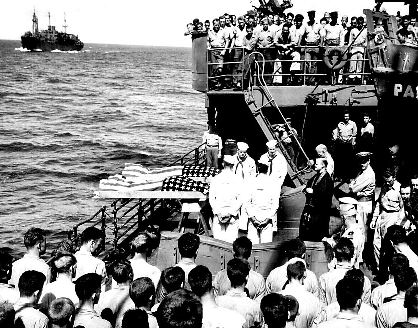 Two enlisted men of the ill-fated U.S. Navy aircraft carrier LISCOME BAY, torpedoed by a Japanese submarine in the Gilbert Islands, are 
buried at sea from the deck of a Coast Guard-manned assault transport. November 1943